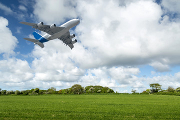 Fototapeta na wymiar Flight of a passenger plane over the meadows