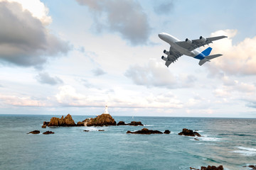 Fototapeta na wymiar Flight of a passenger plane by the sea.