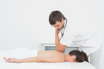 Obraz na płótnie Canvas Male physiotherapist massaging womans back