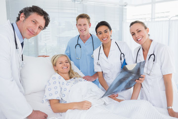 Smiling doctors showing xray to patient