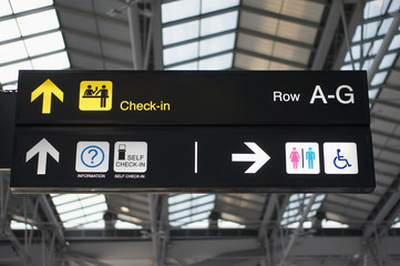 Self check-in and toilets board sign at international airport