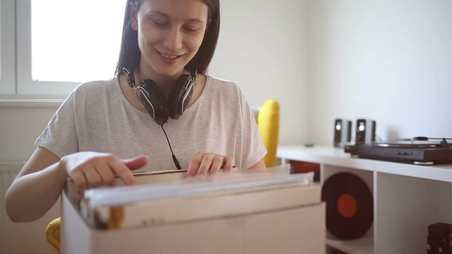 Young woman searching through vinyl records