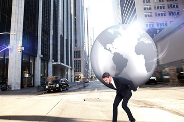 Businessman carrying the world against new york street