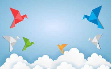 Origami made colorful bird with origami clouds. Paper art and craft style