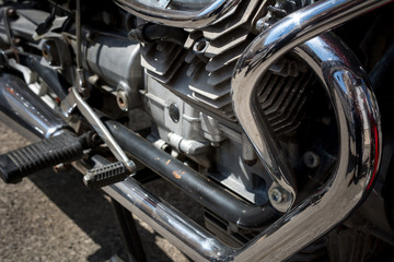 Fototapeta na wymiar Close Up of the Chrome Parts of an Engine of a Custom Motorbike