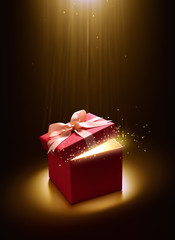 Pink open gift box with magical light