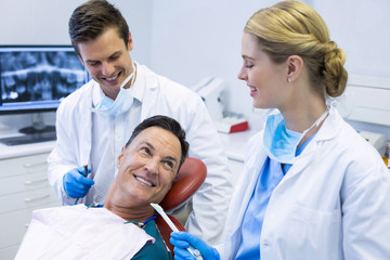 Dentists interacting with a male patient