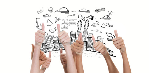 Thumbs raised and hands up  against cityscape with brainstorm doodle