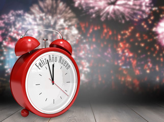 Feliz ano nuevo in red alarm clock against wooden planks