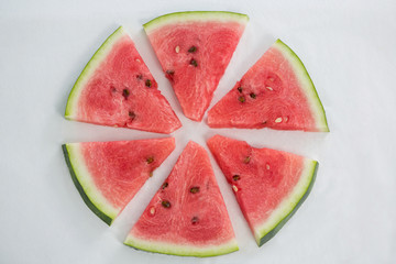 Slices of watermelon arranged on white background