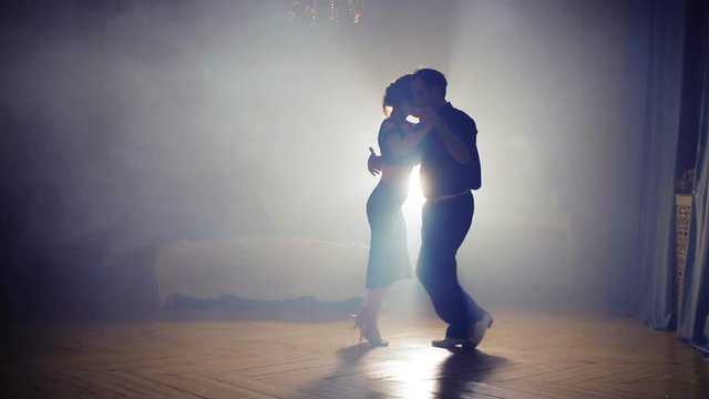 Couple dancing rhumba in the fog