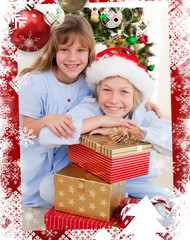 Obraz na płótnie Canvas Smiling siblings holding Christmas gifts against christmas themed frame