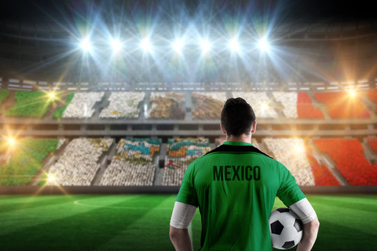 Mexico football player holding ball against stadium full of mexico football fans