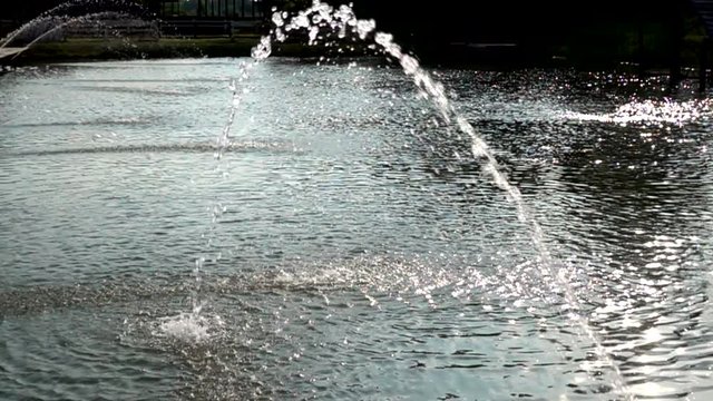 Fountain sprinkled in the pond slowmotion