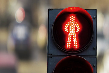 pedestrian traffic lights red on a background of cars