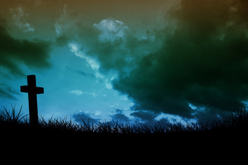 Wooden cross against sky and field