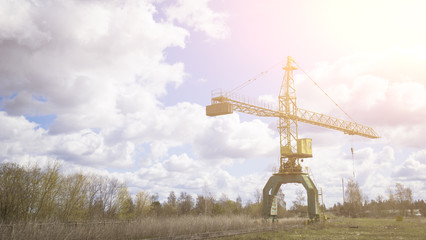 Old, rusty gantry crane, an abandoned plant. Collapse of economy, and shutdown of production...