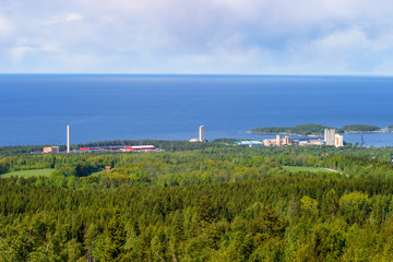 View of forest and lake with an industrial area