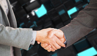 Two people having a handshake in an office against blue and black tile design