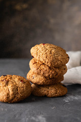 Homemade oatmeal cookie on the black table. Freshly baked oatmeal raisin cookies.