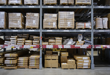 Racks with boxes are in storage room