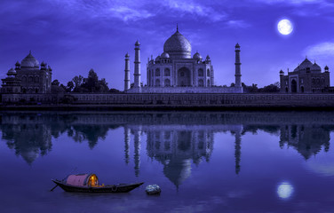 Taj Mahal Agra in full moon night with wooden boat on river Yamuna. Photograph shot from Mehtab Bagh. © Roop Dey