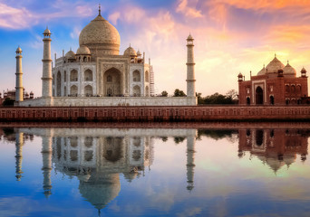 Fototapeta na wymiar Taj Mahal Agra India with east gate at sunset with moody sky.