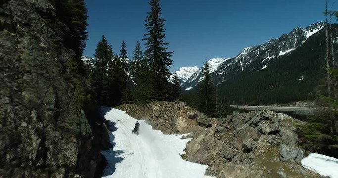 Snowmobile Motorsport Winter Snowy Trail Riding Through Rocky Cascade Mountain Pass