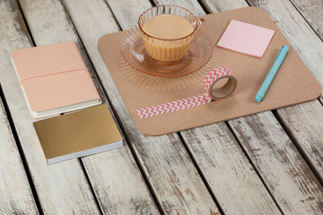 Cup of tea, sticky notes, diary, notepad, printed sellotape and pen