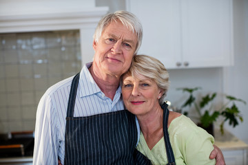 Senior couple standing in kitchen