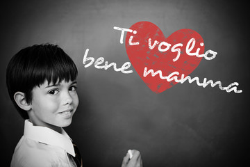 Italian mothers day message against schoolchild with blackboard