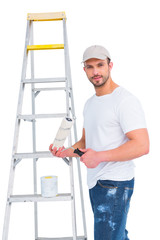 handyman with paint roller and ladder