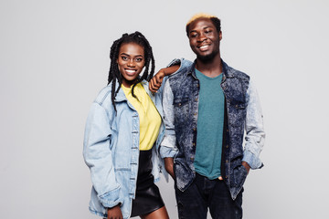 Afro american couple in casual clothes smiling at camera on white background