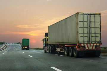 Naklejka na ściany i meble Truck on highway road with container, transportation concept.,import,export logistic industrial Transporting Land transport on the asphalt expressway with sunrise sky