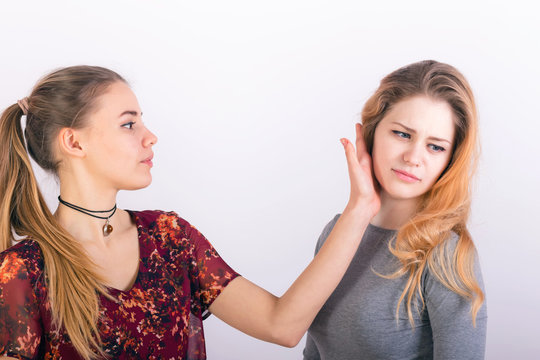 Two young woman fighting, a slapping in the face