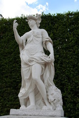 The white stone statue of Africa in Versailles gardens in summer day