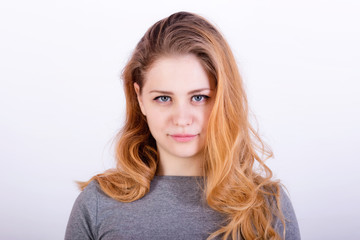Naklejka premium Portrait of a charming young woman with long red hair