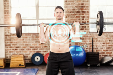 Muscular serious man doing weightlifting against fitness interface