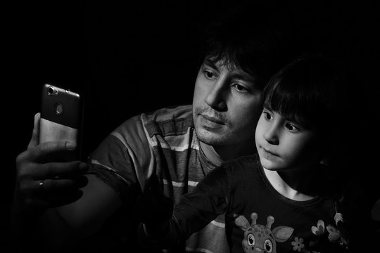 Portrait Of A Father And Daughter In A Low Key. Do Selfie