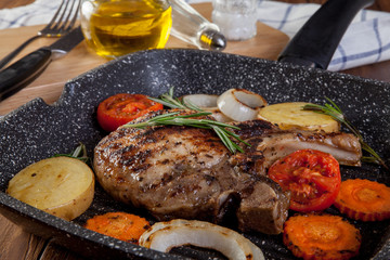 Pork Chop Steak in frying pan, close up view.