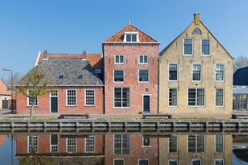 Facade of Houses along a canal in Makkum, an old Dutch village in Friesland