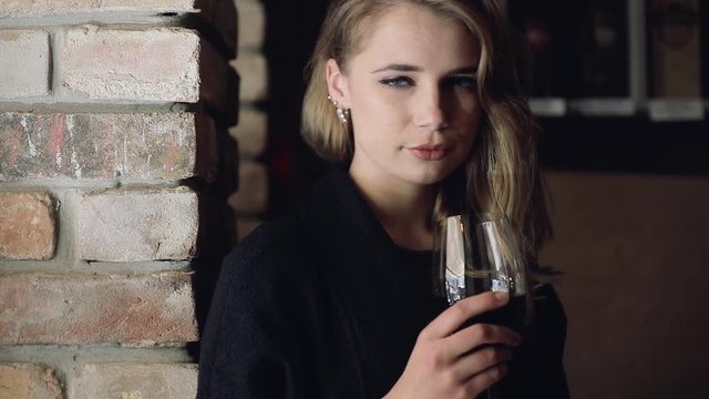 Beautiful young woman holding wine glass