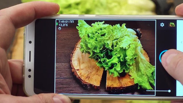 Take A Photo On Mobile Phone Of Long Submarine Subway Sandwich With Fresh Lettuce. Wooden Background.