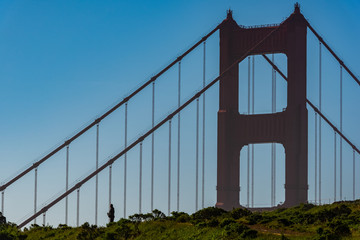 Man alone viewing the Golden Gate Bridge up close 