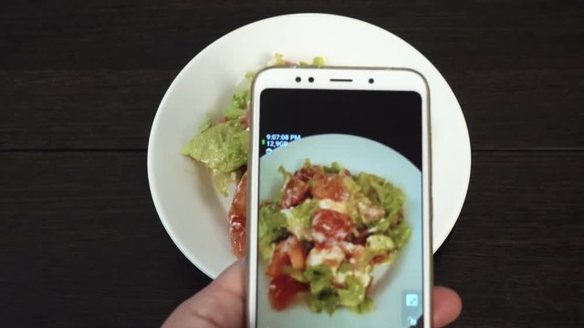Rotating plate with vegetable salad on white plate. Smartphone food photography.