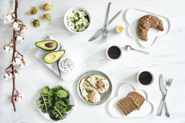 Enjoy healthy breakfast. Top view of different vegetarian food on the white marble table background.