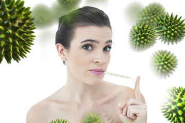 Upset natural brown haired model using a thermometer against virus