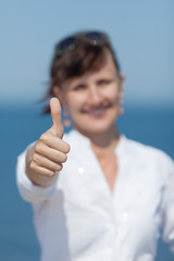 Middle aged woman showing thumb up