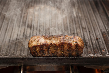 sizzling beef stake on a grill, horizontal