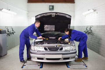 Mechanics looking at the engine